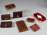 several pieces of leather are arranged on a white surface