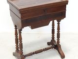 an old wooden table with a drawer on top of it