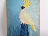 painting of a cockatoo perched on a boot on a blue background