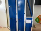 two blue lockers in a room next to a tv