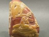 a stone with a carving of a man and a woman on a boat