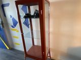 a glass display case with a camera on top of it