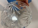 a person holding a clear glass object in their hand