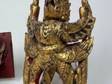 a gold statue of a man on a dragon