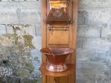 a tall wooden shelf with a bowl on top of it