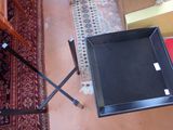 a black tray sitting on top of a table next to a chair