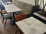 many tables and chairs in this small restaurant