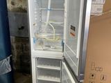 a refrigerator that is sitting in the middle of a room