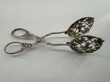 pair of antique silver plated scissors on a white surface