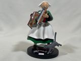 a figurine of a woman holding a book and a cat
