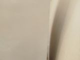 a white refrigerator sitting next to a white wall