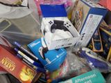 a pile of school supplies in a bin on the floor