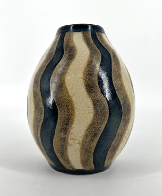 a black and white striped vase on a white surface