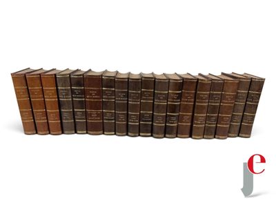 a group of books sitting on top of each other on a white surface