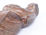 a statue of a turtle made of wood on a white surface