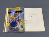 an open book with a picture of a painting on it
