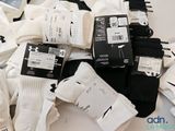 several pairs of white and black socks are on a table