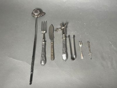 a lot of silverware on a table with a spoon and knife