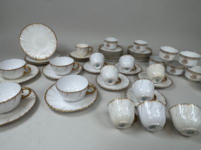 a lot of white and gold china on a table