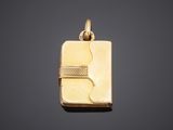 a gold pendant with a letter b on a black background