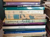 many books stacked on top of each other on a table