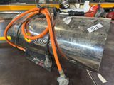 a metal tank with an orange hose attached to it