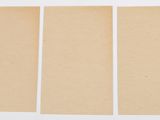 three pieces of brown paper are sitting next to each other