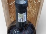 a bottle of wine in a wooden box on a table