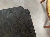 a chair with a yellow seat next to a black book