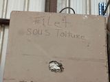 a cardboard box sitting on top of a shelf in a warehouse
