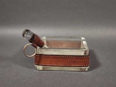 a small glass box with a keychain on top of it