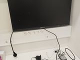 a flat screen tv mounted on a wall above a desk