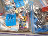 a lot of toys in the plastic bag on the table