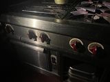 a pot sitting on top of a stove in a dark room