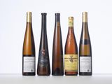 several bottles of wine are lined up on a table