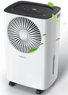 a white and black air purifier with green leaves coming out of it