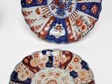 three plates with different designs on them sitting on a white surface