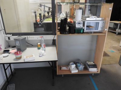 a desk with a mirror and a microwave on top of it
