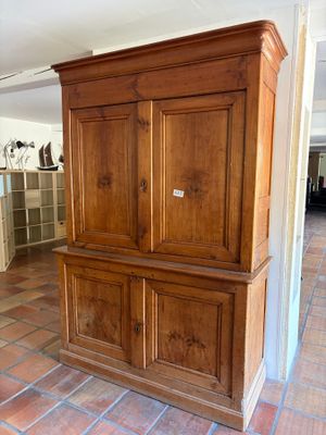 a large wooden cabinet in the middle of a room
