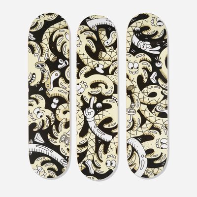 two skateboards with a pattern of skulls on them on a white surface