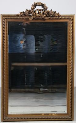 a mirror that is sitting on the floor in front of a shelf