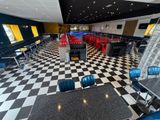 a checkered floor in a restaurant with chairs and tables