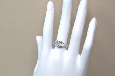 une image représentant la main d'une femme portant une bague en diamant