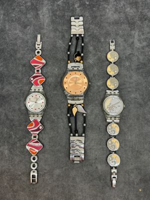 trois montres différentes posées les unes à côté des autres sur une table