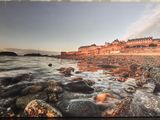 an image of a picture of a beach with rocks in the foreground