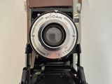 an old camera hanging on a wall in a room