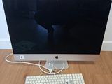 a computer with a keyboard and mouse on a wooden floor
