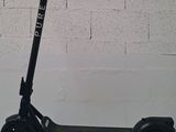 a scooter that is sitting against a wall