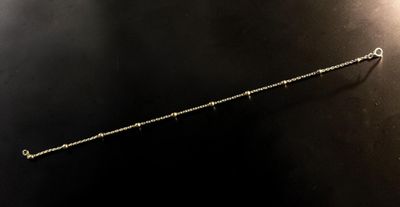 a close up of a metal object on a black surface