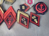 several military badges are laid out on a cloth surface
